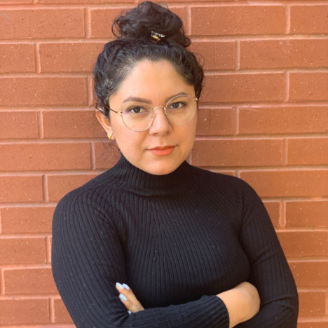 Constanza Salazar headshot photo with brick background.