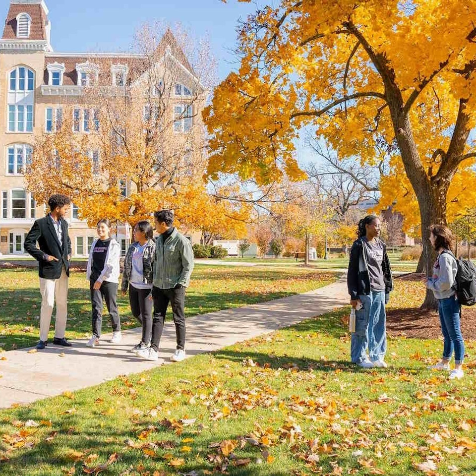 Students in outdoor area of Ragdale college with fall foliage